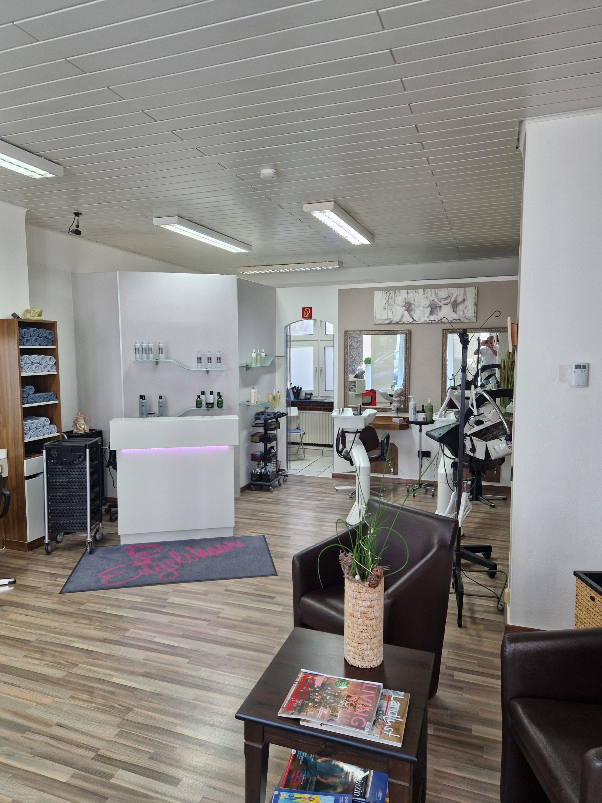 Innenansicht Friseursalon mit Wartebereich, Theke und Bedienplätzen