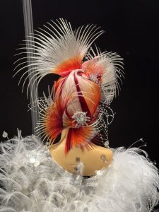 Kunstvolle Hochsteckfrisur von hinten mit orangen und silbernen Haaren sowie lila-Strähnen